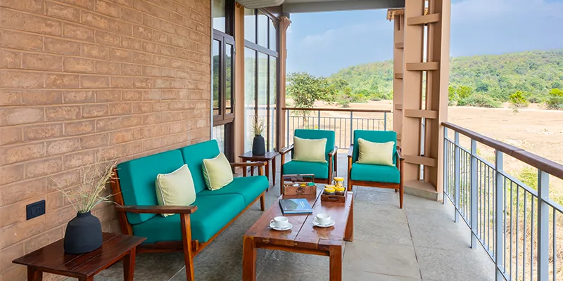 Private veranda with comfortable lounge chairs overlooking the forest